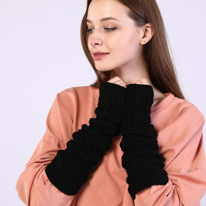 Black twist-knit fingerless arm sleeves, ribbed cuff, worn on forearms