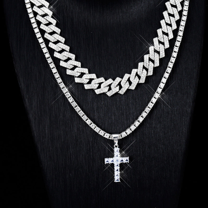 Silver chain necklace with a cross pendant on a black background