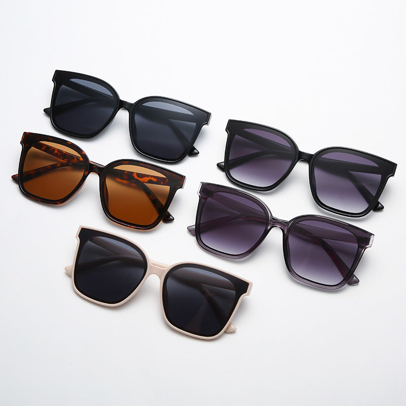 Four pairs of sunglasses with different frame colors and lens tints on a white background