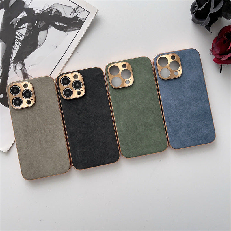 Four phone cases in different colors on a light surface with a magazine and flowers in the background.