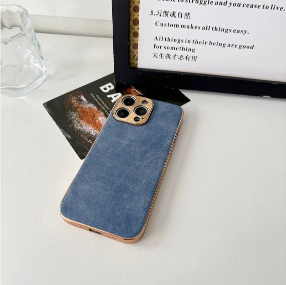 Blue phone case with gold accents on a white surface