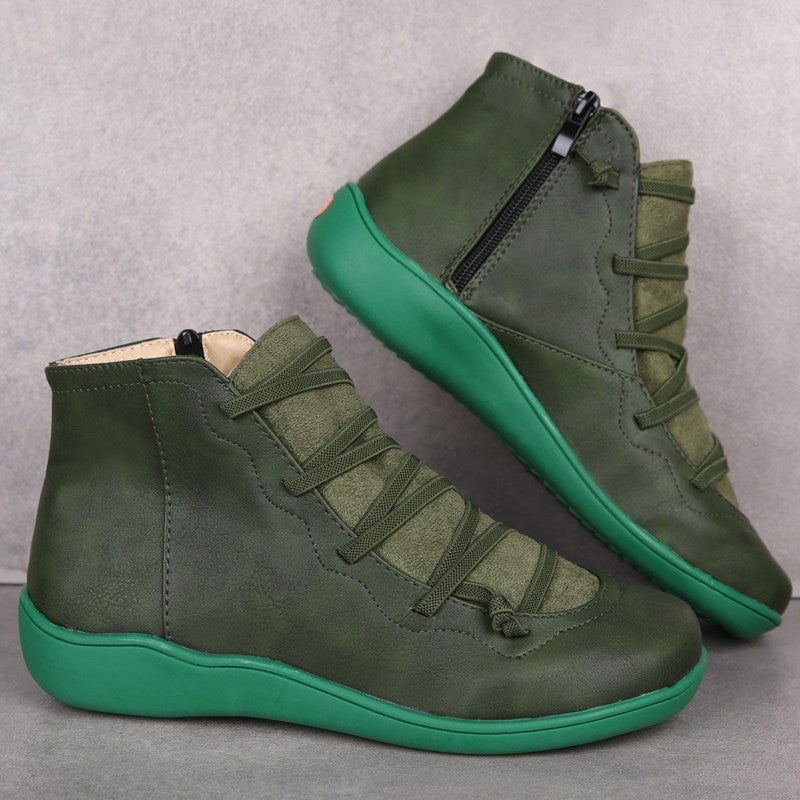 Green high-top sneakers with green soles on a gray background