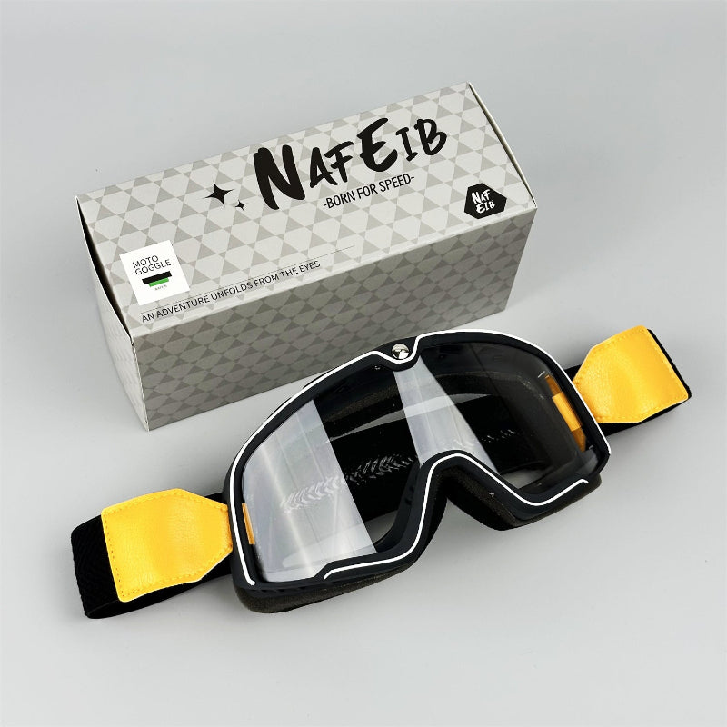 Goggles with yellow accents and a branded box on a gray background