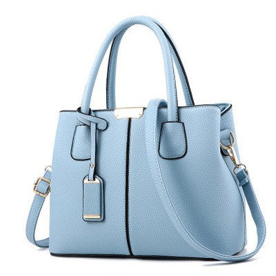 Light blue leather shoulder tote bag with structured shape, top handles, and side straps