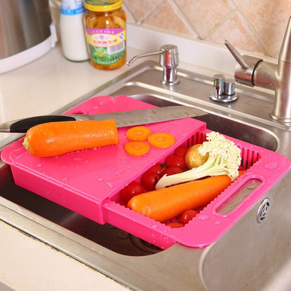 Pink cutting board with vegetables on a kitchen sink