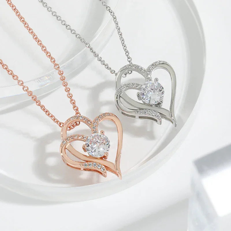 Rose gold and silver-tone double heart pendant necklaces with central round stones