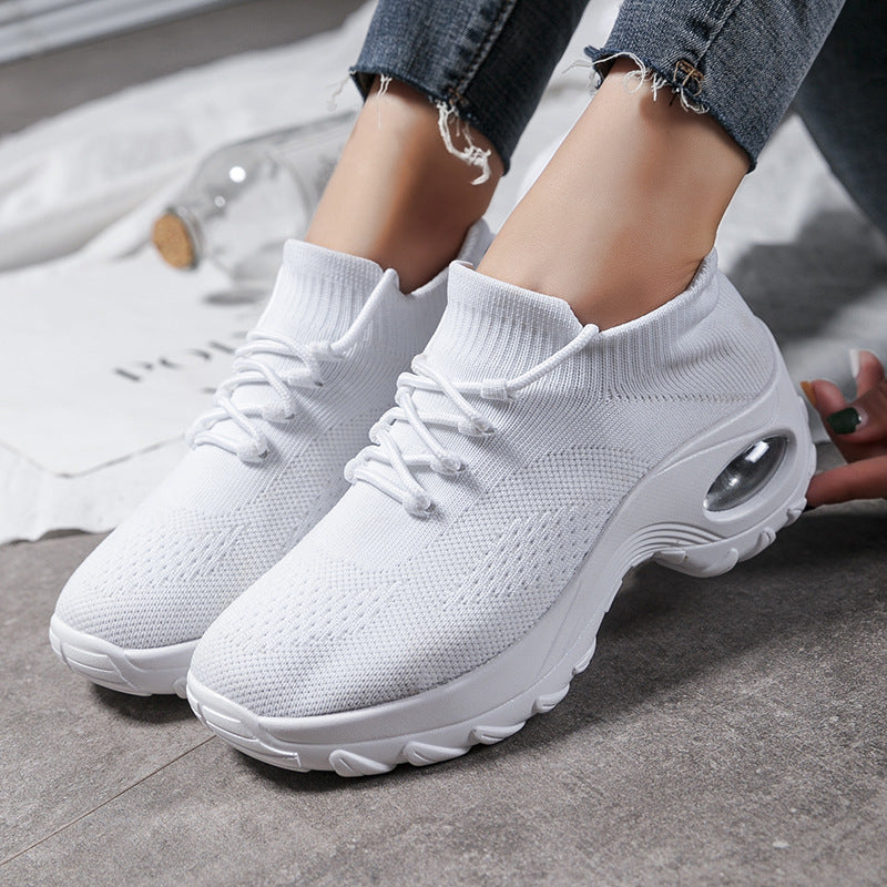 White knit lace-up athletic shoes with cushioned sole and oval air window detail