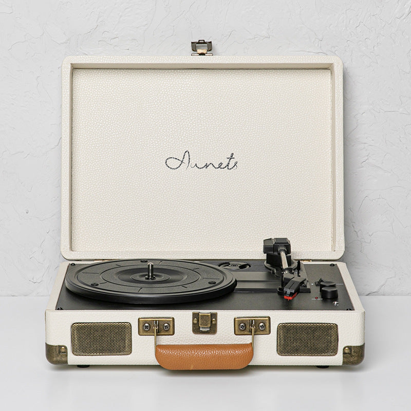Cream portable Bluetooth record player phonograph with open lid and turntable