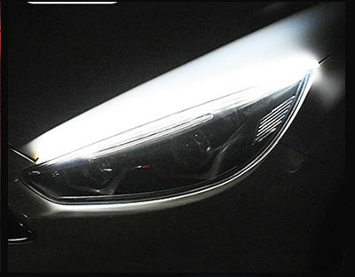 Car LED daytime running light strip close-up with bright white light bar