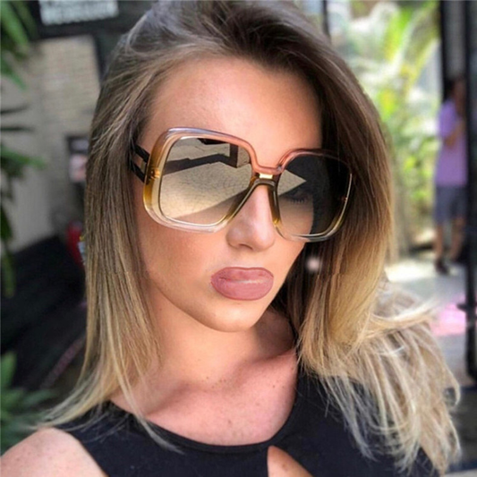 Woman wearing large sunglasses with a blurred background