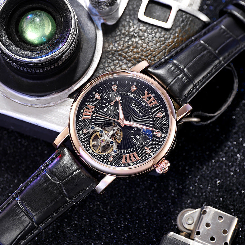 Mechanical watch with rose-gold case, black dial with orange accents, black leather strap