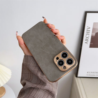 Person holding a brown phone case with a blurred background