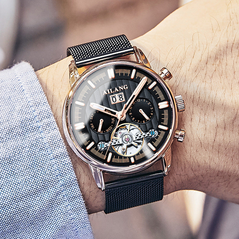 Luxury watch with black mesh strap on a wrist, brand 'YILANG' visible