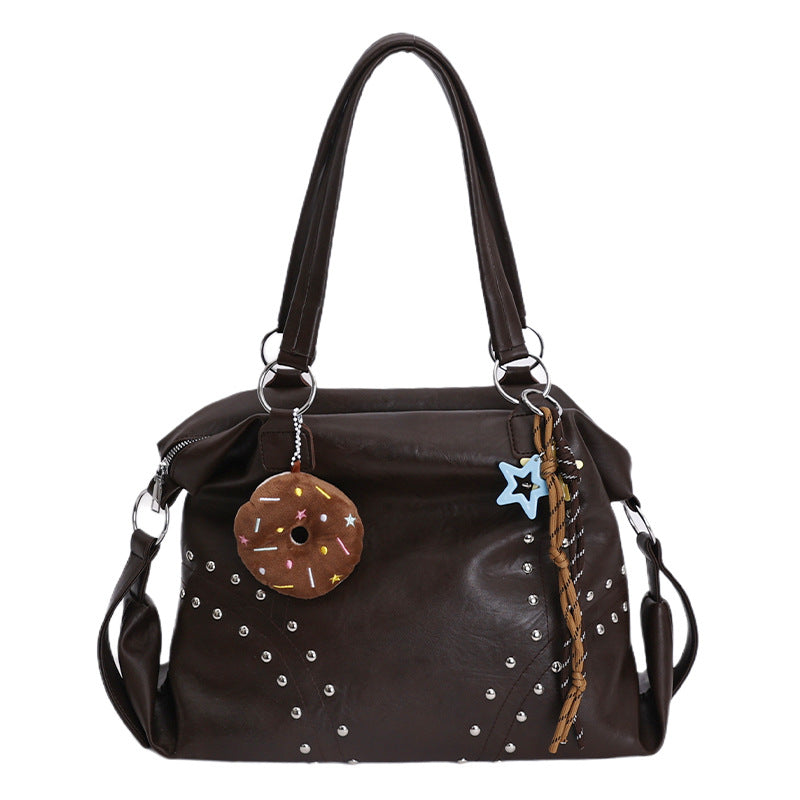 Women's shoulder bag, black with silver studs, donut pendant and star bag charm