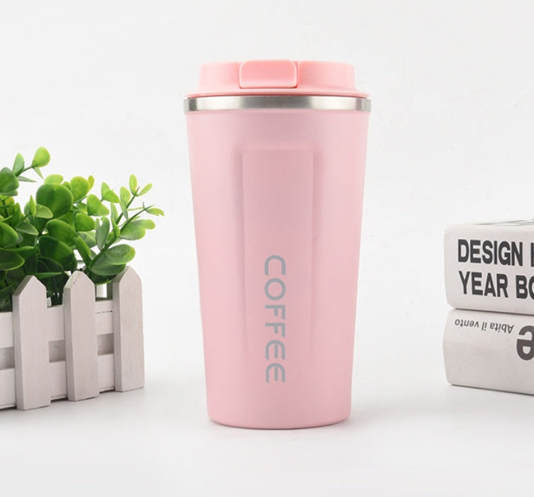 Pink insulated coffee tumbler with 'COFFEE' text on a white background