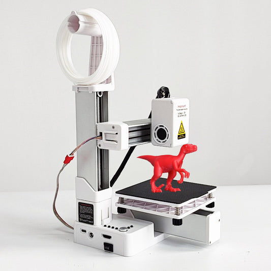 White portable 3D printer with filament spool and build plate, printing red dinosaur figurine