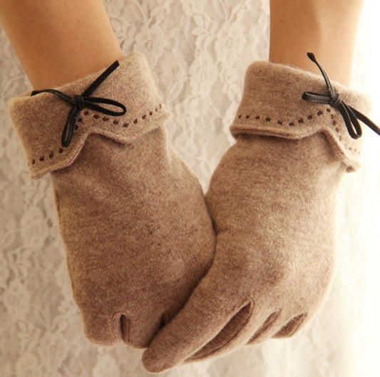 Pair of taupe winter gloves with stitched cuff and bow detail at wrist