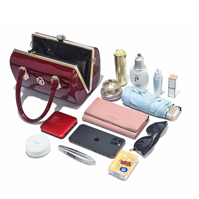 Collection of various items including a handbag, phone, wallet, and accessories on a white background