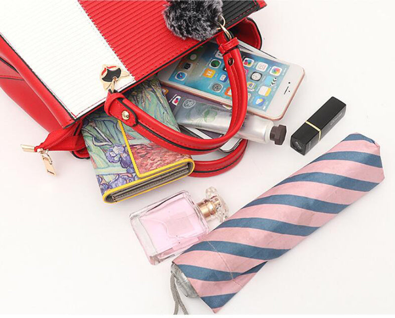 Open color-block PU leather handbag with red interior and pompom charm
