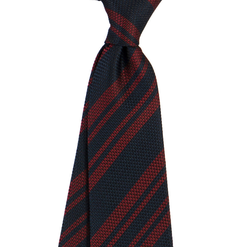 Men's tie in dark navy with red diagonal stripe pattern
