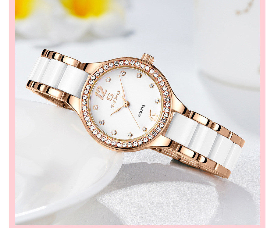 Rose gold and white ceramic watch on a light background