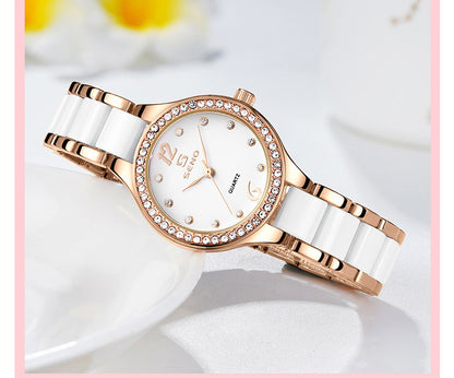 Rose gold and white ceramic watch on a light background