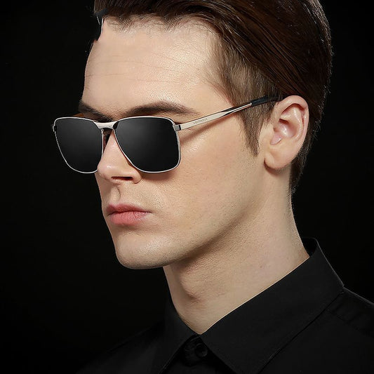 Man wearing black sunglasses against a black background