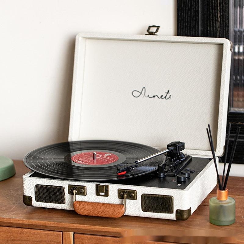 Cream portable Bluetooth record player phonograph with tonearm and record on platter