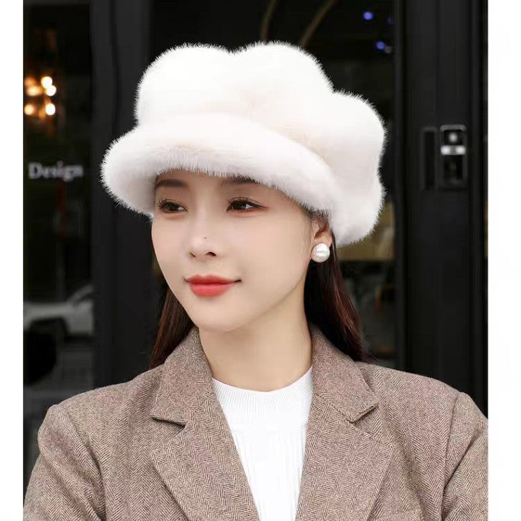 Woman wearing a white fur hat and brown coat in an indoor setting