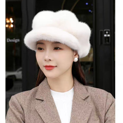 Woman wearing a white fur hat and brown coat in an indoor setting