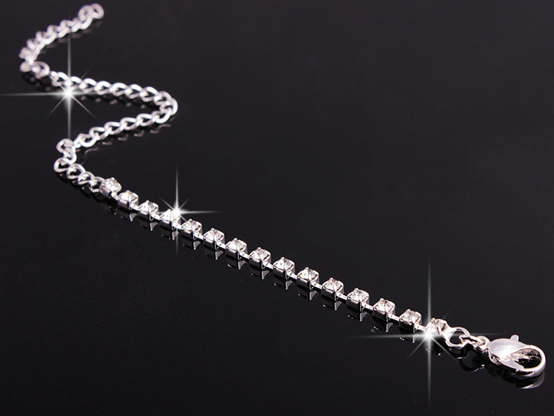 Rhinestone tennis bracelet with silver-tone chain and lobster clasp