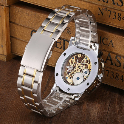 Silver watch with a detailed mechanical face on a wooden surface
