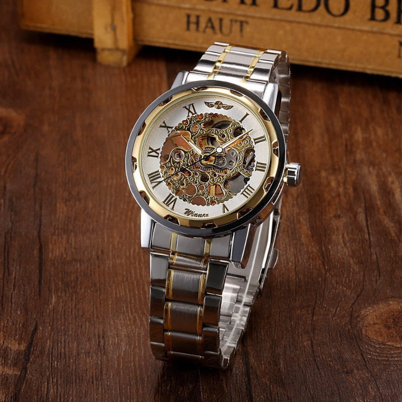 Two-tone mechanical skeleton watch on metal bracelet, front dial with Roman numerals