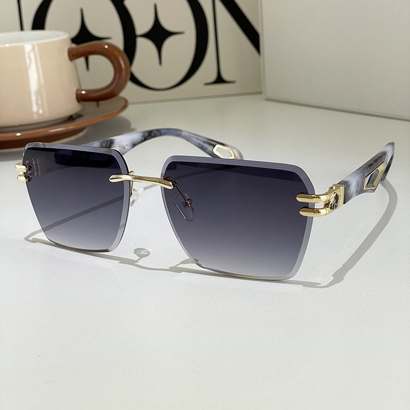 Square sunglasses with dark lenses, marbled blue-gray arms, gold-tone accents