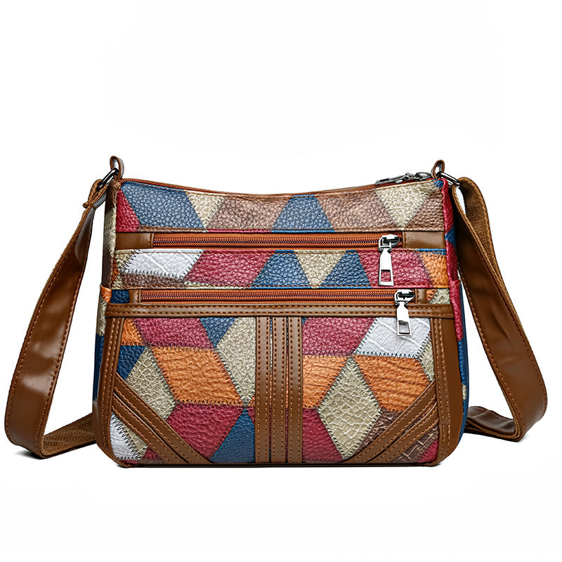 Women's patchwork crossbody bag with brown straps and two front zip pockets