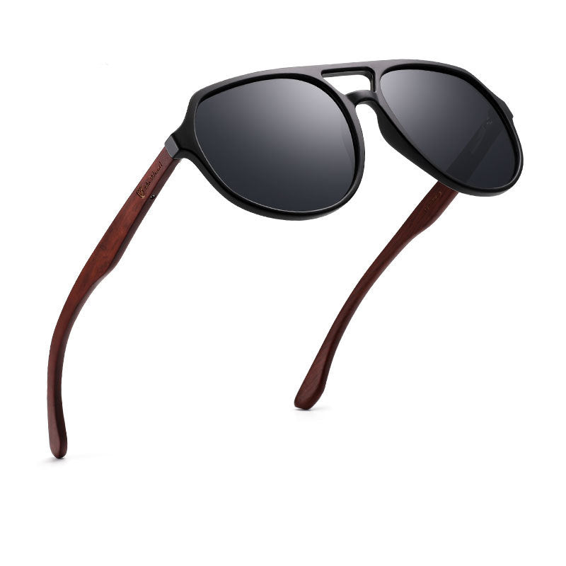 Sunglasses with black lenses and wooden arms on a white background