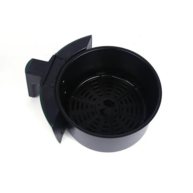 Black air fryer basket pan removed, showing perforated nonstick interior.