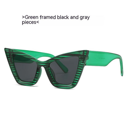 Green framed cat-eye sunglasses with dark black and gray tinted lenses