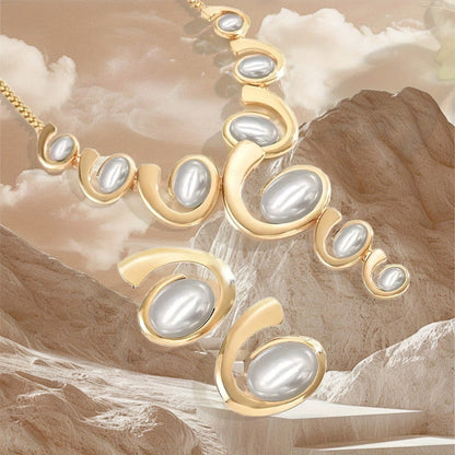 Gold necklace with pearls on a textured beige background