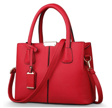 Red leather shoulder tote bag with gold-tone hardware, top handles, and crossbody strap