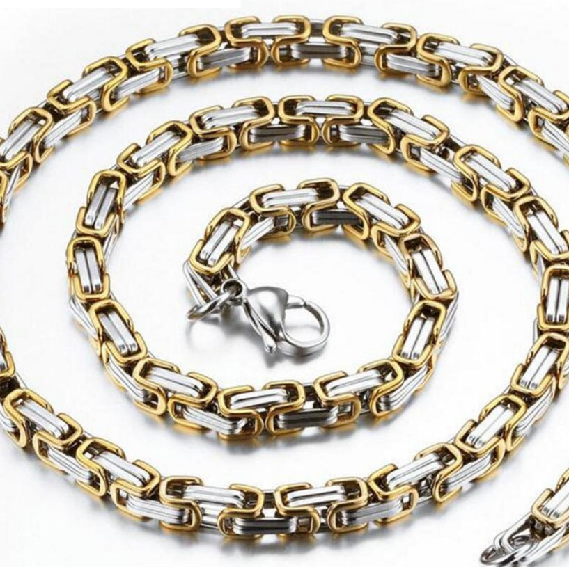 Gold and silver chain necklace on a white background