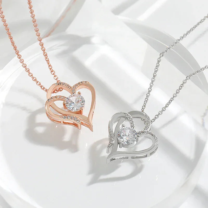 Rose gold and silver-tone double heart pendant necklaces with round crystal center stones