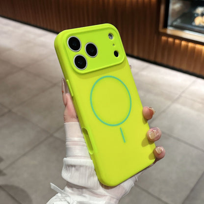 Hand holding a lime green phone case with a blue circle design.