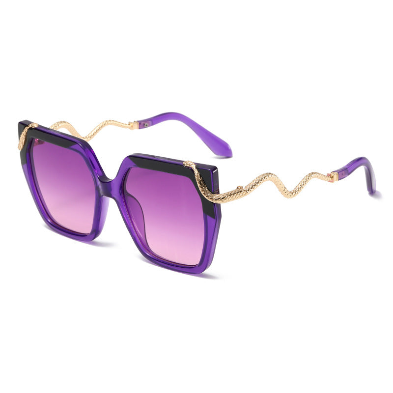 Purple sunglasses with gold chain detail on a white background
