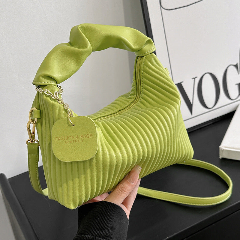 Lime green ribbed PU leather crossbody bag with gold chain detail and heart charm tag