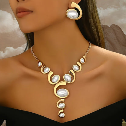 Gold necklace with pearl-like stones worn by a model against a neutral background