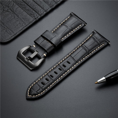 Dark leather watch strap set with two buckles and yellow edge stitching.