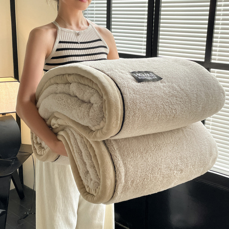 Cream solid fleece blanket roll-up with small “HOME” patch on the top fold