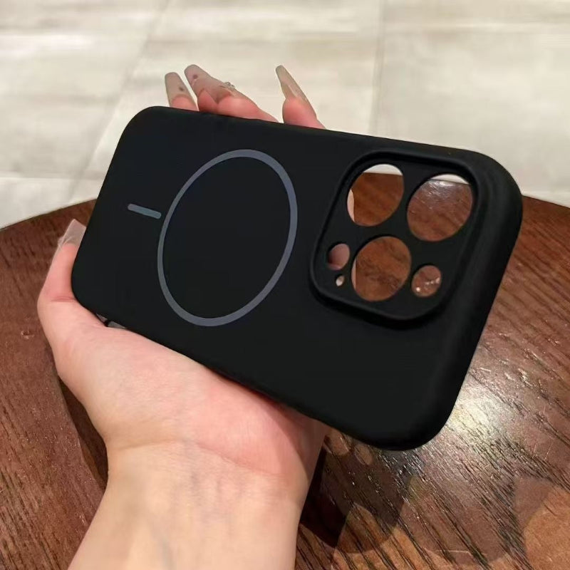 Black phone case held by a hand on a wooden surface with a white background