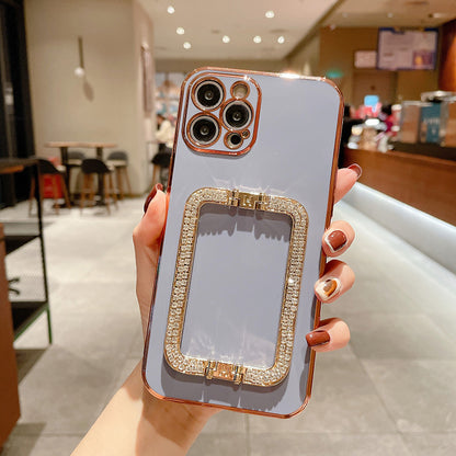 Phone case with rose gold frame held by a hand in an indoor setting